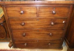 A Victorian mahogany chest of two short and three long drawers with turned wooden handles,