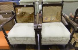 A pair of early 20th Century stained beech framed and caned low armchairs