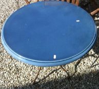A blue ceramic topped garden table on iron base
