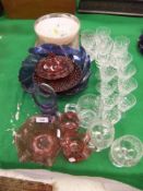 A collection of glassware to include a cranberry glass flared bowl and two cranberry glass jugs,