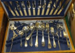 An oak cased plated canteen of mixed cutlery