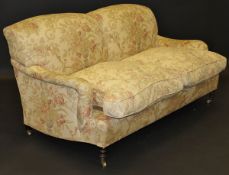 A George Smith two seat sofa and two armchairs in the Howard style, with cream ground foliate