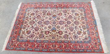 An Isfahan rug, the central cream ground with all-over stylised and foliate decoration in pale