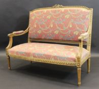 A late 19th Century French walnut framed salon settee in the Louis XVI taste with all over ribbon