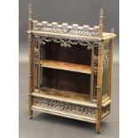 A 19th Century French Gothic style oak wall hanging cabinet with open shelf within ornate carved