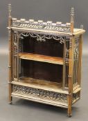 A 19th Century French Gothic style oak wall hanging cabinet with open shelf within ornate carved
