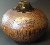 A Janet Leach Leach Pottery vase, temoko glaze, with stylised bark incised decoration, 21 cm high