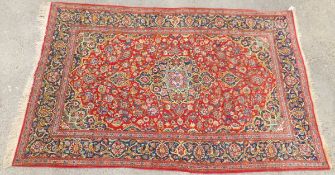 A Kashan rug, the central floral medallion in pale blue, dark blue, mustard, red and lime,