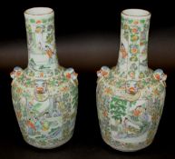 A pair of 19th Century Chinese famille verte vases decorated with panels of scholars and musicians