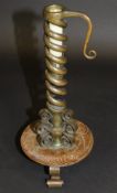 An Arts and Crafts gilded brass spiral twisted candlestick, the base marked "T. Potter & Sons 44.