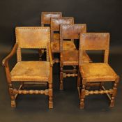 A set of five Robert Thompson of Kilburn "Mouseman" oak framed dining chair with leather and brass