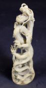 A 19th Century Japanese Meiji period carved ivory figure of a three toed water dragon emerging from