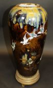 A late 19th Century Japanese slip glazed pottery vase decorated in gilt and enamels with swooping