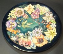 A Moorcroft pottery charger decorated in the "Carousel" design by Rachel Bishop,