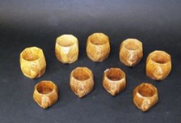 Nine assorted Robert "Mouseman" Thompson oak napkin rings of octagonal form,