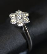 An 18 carat white gold mounted diamond cluster ring, the centre stone approx 0.