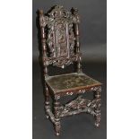 A 17th Century style carved oak hall chair,