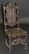A 17th Century style carved oak hall chair,