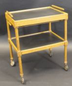 A circa 1900 oak two tier tea trolley in the Gothic revival taste with a single cutlery drawer,