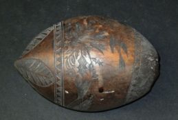 A burr walnut carved prisoner coconut with stylised lion, trees, birds,