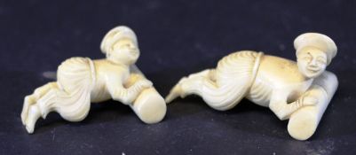 A pair of 19th Century Chinese carved ivory chopstick rests as figures pushing logs, 6.5 cm and 7.