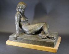 An early 20th Century patinated bronze figure of a reclining nude on a rectangular base,