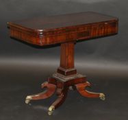 A Victorian mahogany fold-over card table on single square section tapering column, to quatrefoil