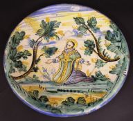 An 18th Century Italian Maiolica charger decorated with kneeling Saint, the light of the Lord