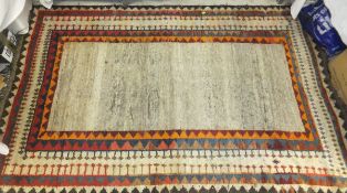A Caucasian rug, the plain cream / taupe centrefield within cream, orange, blue,