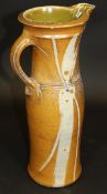 A Michael Casson slipware decorated jug of elongated baluster form with flared rim, 41 cm high