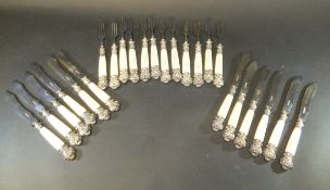 A set of twelve mother of pearl handled knives and forks