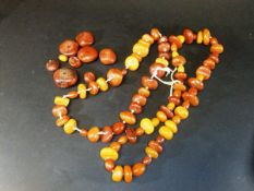 A rough cut amber bead necklace, various sizes and colours of beads,