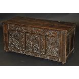 A 17th Century Welsh oak coffer, the later two plank top over a stylised dragon/serpent decorated