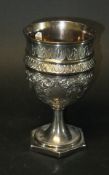 An early 19th Century hollow silver goblet with embossed decoration on a hexagonal foot (by Duncan