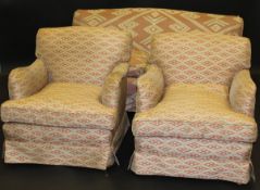 A Howard two seat sofa and two single armchairs in salmon pink ground abstract patterned upholstery,
