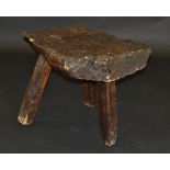A 19th Century walnut pig bench on three simple legs,