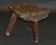 A 19th Century walnut pig bench on three simple legs,