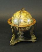 A miniature 1960's Italian made terrestrial globe on a brass stand,