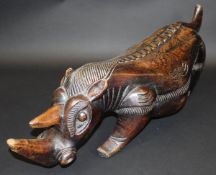 An African carved wooden figure of a rhinoceros,