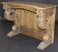 A Victorian Gothic Revival oak console table with heavily carved decoration of grapes on vine and