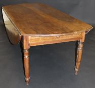 A 19th Century French fruitwood oval drop leaf dining table with two end drawers on turned and