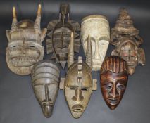 Seven various African wooden masks including a Fang mask decorated with white pigment,