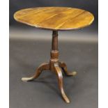 A 19th Century yew tea table, the circular snap top on bird cage pedestal to cabriole tripod base,