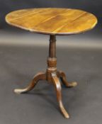 A 19th Century yew tea table, the circular snap top on bird cage pedestal to cabriole tripod base,
