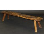 A 19th Century oak pig bench on four splayed supports,