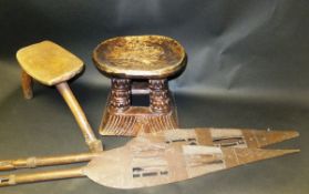 A Lobi wooden three legged stool, an African carved wooden stool,
