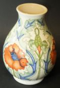 A Moorcroft baluster shaped vase decorated in the "Poppy" pattern on a cream ground,