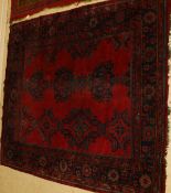 A Turkey carpet, the three central linked medallions in blue and green on a red ground,