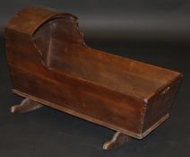 A 19th Century oak child's crib, the plain domed top with shaped side supports,