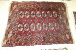 A Bokhara rug, the two central rows of elephant foot medallions in cream, red,